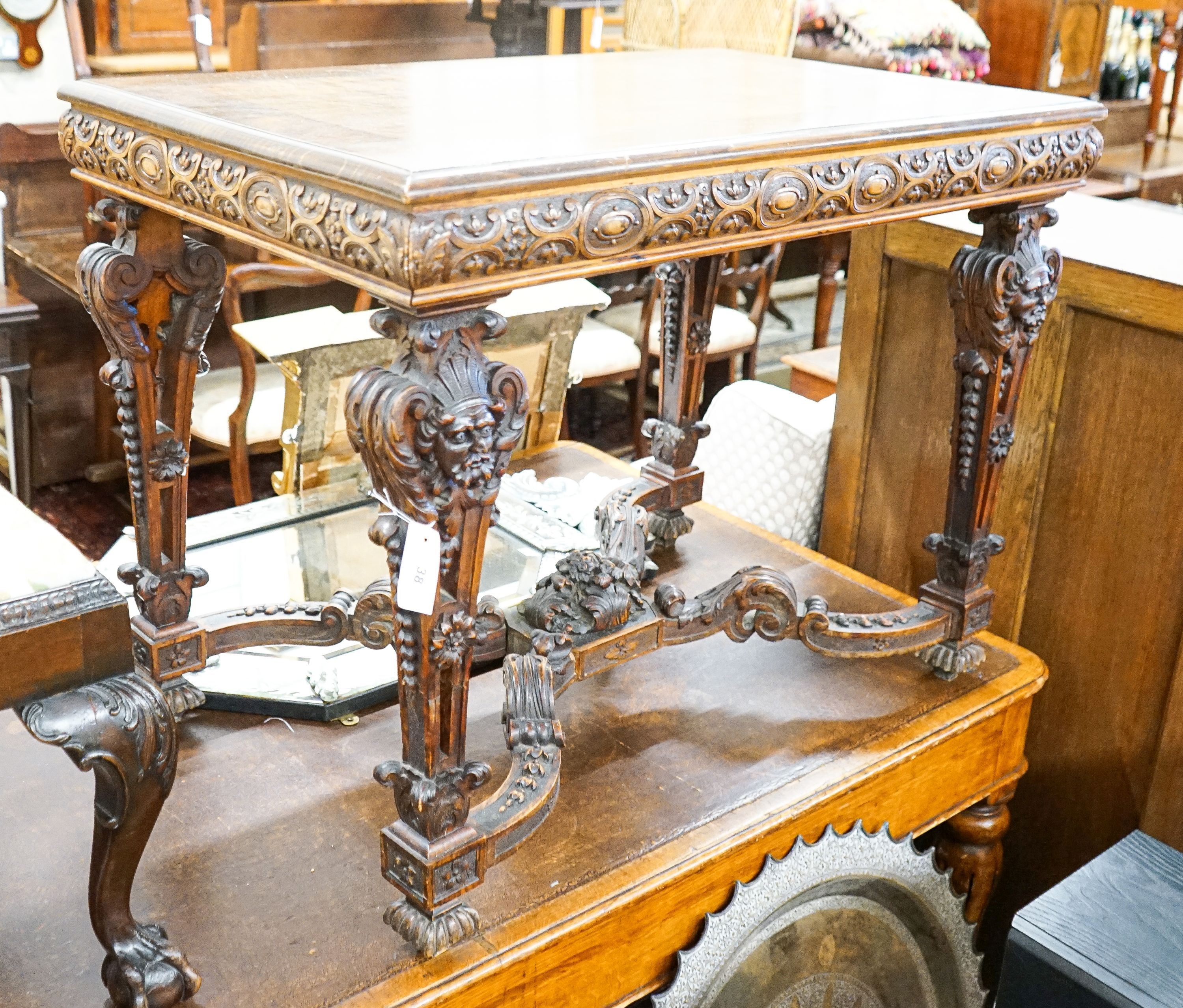 A Flemish carved walnut and beech centre table, width 100cm, depth 63cm, height 77cm